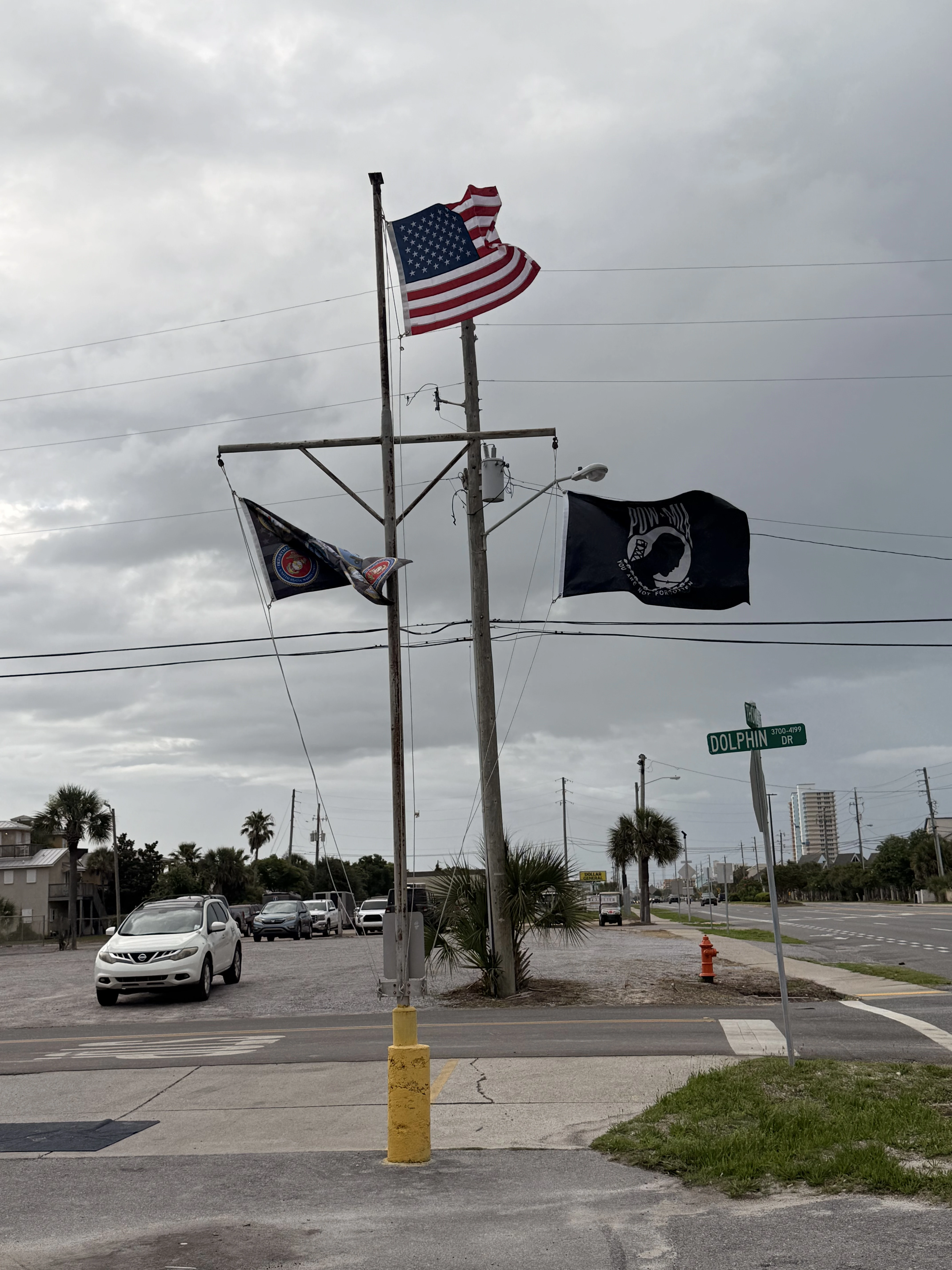 Flagpole at Buster's Beer and Bait Panama City Beach FL — American flag POW MIA Marine Corps — sunset salute every evening